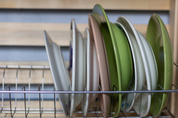 dish dryer with row of plates in kitcjen 