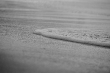 Wave On Sandy Beach. Background. Splash of waves on the sandy beach. foam, surf, waves.