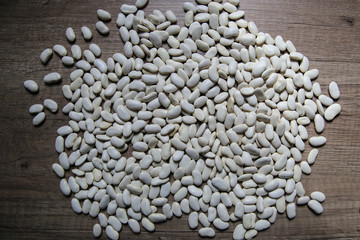 White beans on wooden background