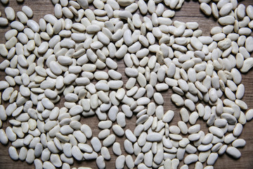 White beans on wooden background
