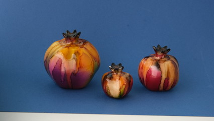 ceramic pomegranate on a blue background