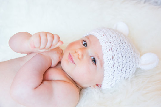 Cute Baby Girl Smiling and Wearing a Soft Knit Bear Ears Hat