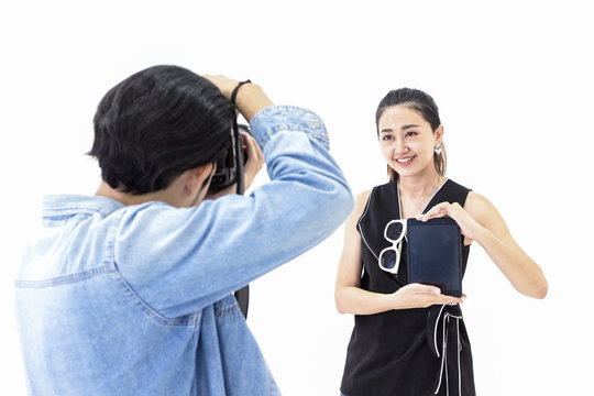 photographer is shooting a model in a modern studio. concept of working as a photographer.