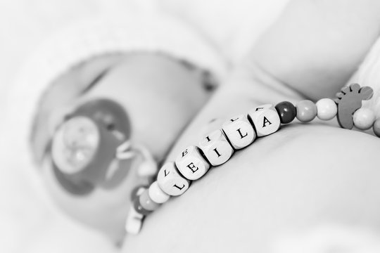 Baby Girl Named Leila Sleeping and Wearing a Wooden Pacifier Chain