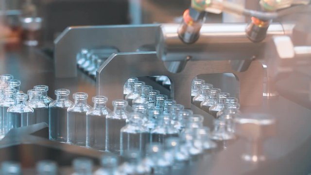 Medical vials on the automatic production line of vaccines and injections. coronavirus.