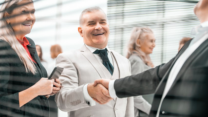 close up. smiling business people greet each other with a handsh