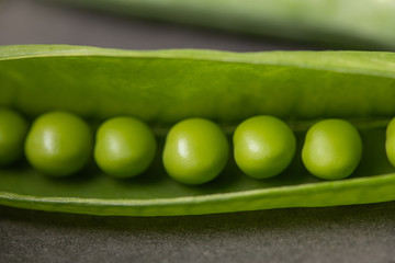 green peas on a wooden background close-up