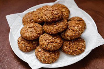 oatmeal cookies on a white plate on a brown background
