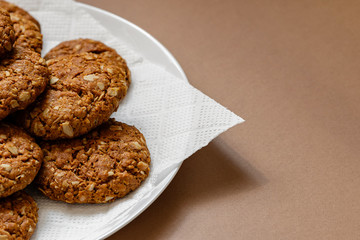 oatmeal cookies on a white plate on a brown background