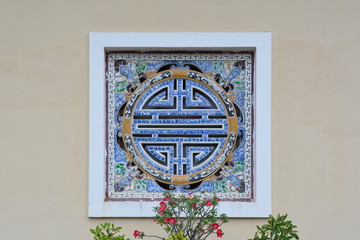 Decorated porcelain window in the Tomb of Tu Duc. Hue, Vietnam