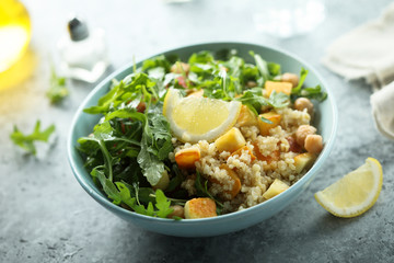 Healthy quinoa bowl with chickpea, cheese and arugula