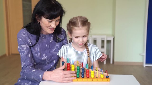 teacher with girl learning to add and subtract