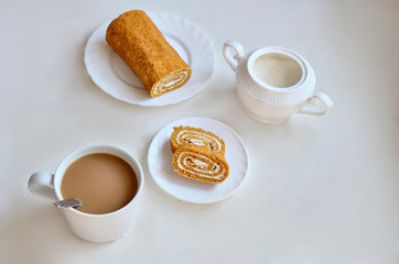 a slice of honey roll with coffee
on a white table
