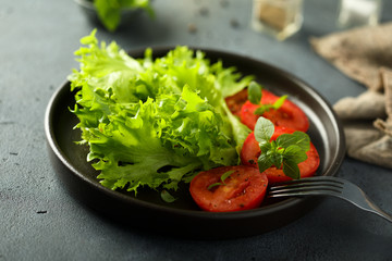 Healthy green salad with fresh tomatoes