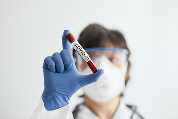 Doctor scientist holding test tube with blood for 2019-nCoV analyzing. Novel Chinese Coronavirus blood test Concept.Vaccine research