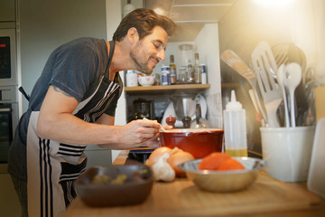 Middle-aged man cooking in his kitchen
