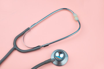 Top view of two part of one single stethoscope isolated on a pink colored background