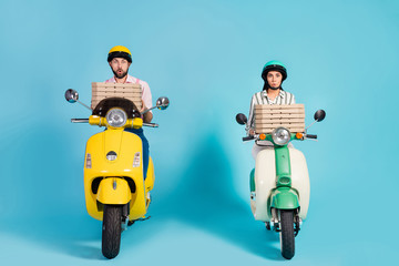 Full size photo of funky lady guy drive two retro moped carry pizza boxes couriers family business fastfood delivery formalwear outfit protective helmet isolated blue color background