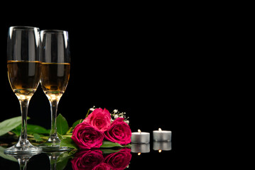 Champagne, red rose bouquet and candles on black background, Valentine’s Day, copy space