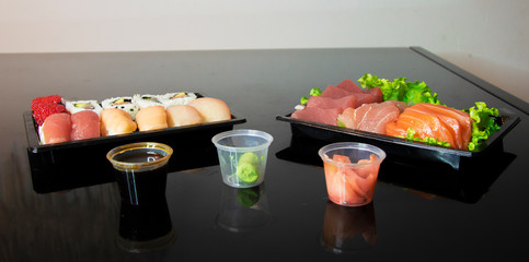 sushi on table with black mirror reflection