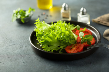 Healthy green salad with fresh tomatoes