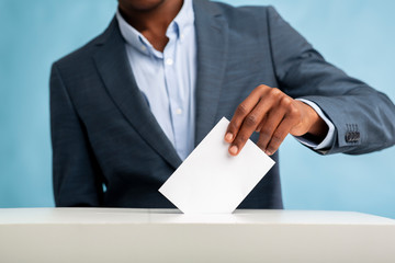 African Man throwing his vote into the ballot box
