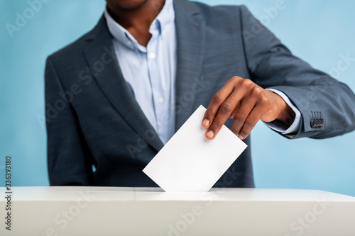 African Man throwing his vote into the ballot box