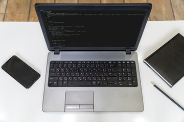 Developer coding on a laptop - top view