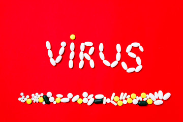 Weapon against COVID-19. Colored pills, tablets and capsules on a red background - history of treatment. Concept of healthcare and medicine, vaccine, prevention of pandemic, epidemic, chronic diseases