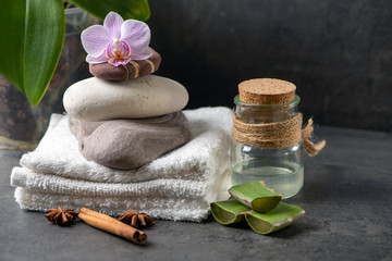 spa still life with towel and orchid  and aloe vera on gray cement background