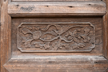 Carved patterns on wooden doors of ancient buildings in Chinese folk villages