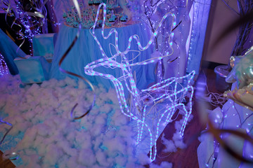 Christmas winter holiday concept wallpaper. Abstract pairs of lover deer of blur silver and blue light bokeh. Blue blurred soft defocused lights background.