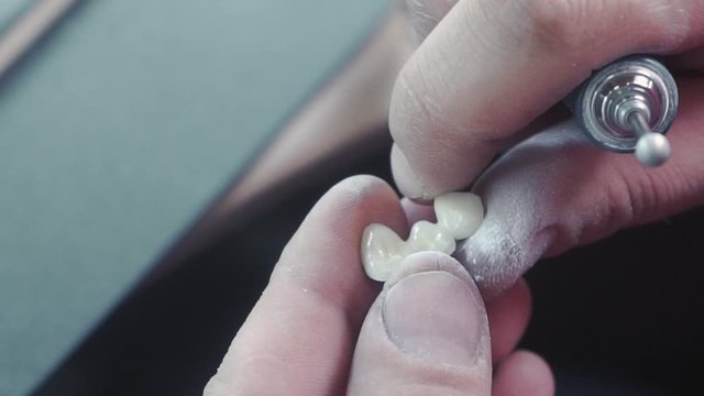 slow motion image of the dental technician who makes a prosthetic tooth