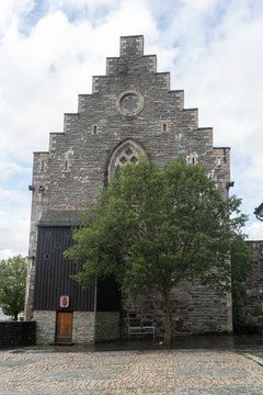 Bergenhus Fortress and a tree in Bergen city of Norway. August 2019
