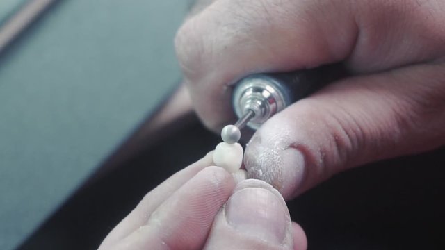 slow motion image of the dental technician who makes a prosthetic tooth