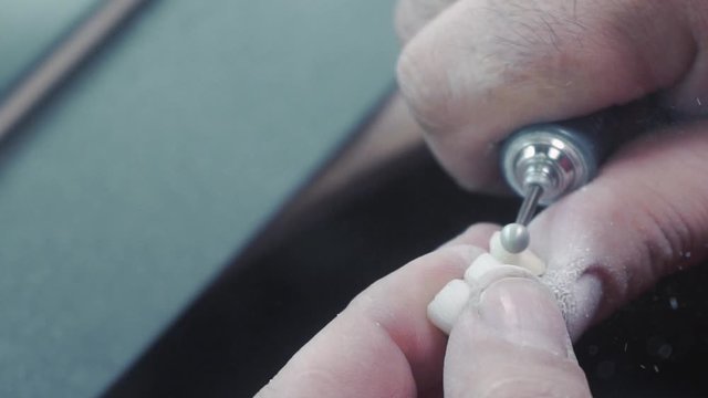 slow motion image of the dental technician who makes a prosthetic tooth