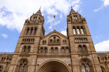 Fototapeta na wymiar Main entrance with two towers on each side presents beautiful and large complex in London named Natural History Museum. The terracotta mouldings represent the past and present diversity of nature.