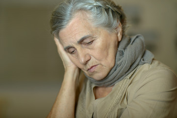 Close up portrait of sad ill senior woman
