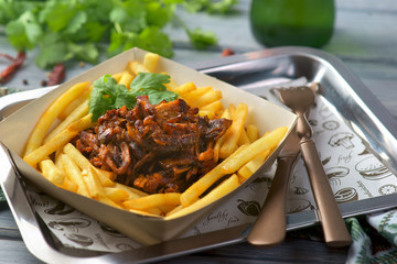 torn pork with French fries in a package for delivery