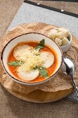 Traditional tomato hot soup served with croutons on the table at restaurant