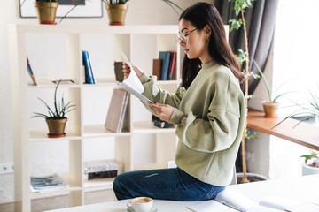 Concentrated young girl student indoors studying