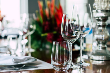 Classic setting traditional fine dining table elegant luxury style with silverware, wine glass, flower on special occasion date, family toast wedding party, anniversary, thanksgiving, christmas dinner