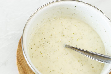 Flat lay above dill sauce in the bowl