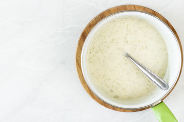 Flat lay above dill sauce in the bowl