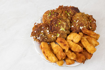 Fried chicken breasts meat with grated potatoes pancakes