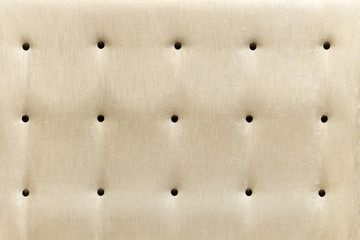beige upholstery of the chair, sofa with buttons