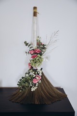 Wedding floristry. Arrangement of flowers and greenery stands on a wooden table