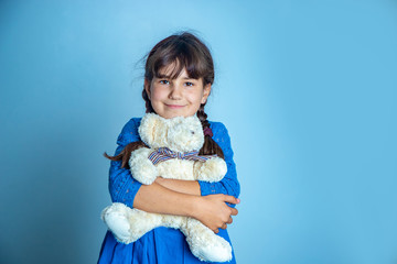 indoor portrait of young child girl with teddy bear, isoalted studio shot