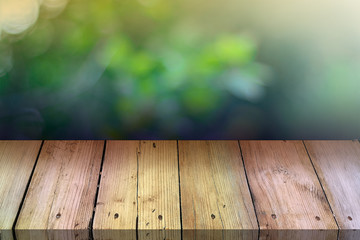 Naklejka na ściany i meble Summer background. Old wood floor with blurred background. Empty table for display montages.