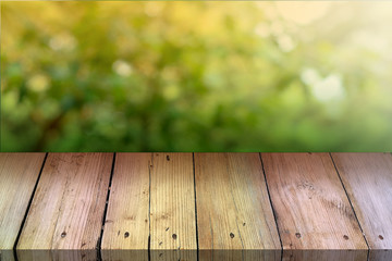 Summer background. Old wood floor with blurred background. Empty table for display montages.